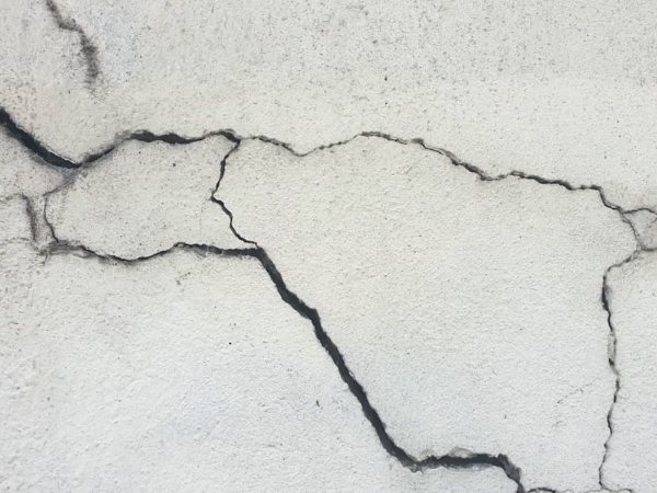 Close-up of cracks running across an old concrete slab